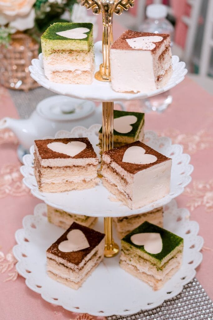 A stylish display of assorted layer cakes on a tiered stand, perfect for celebrations.